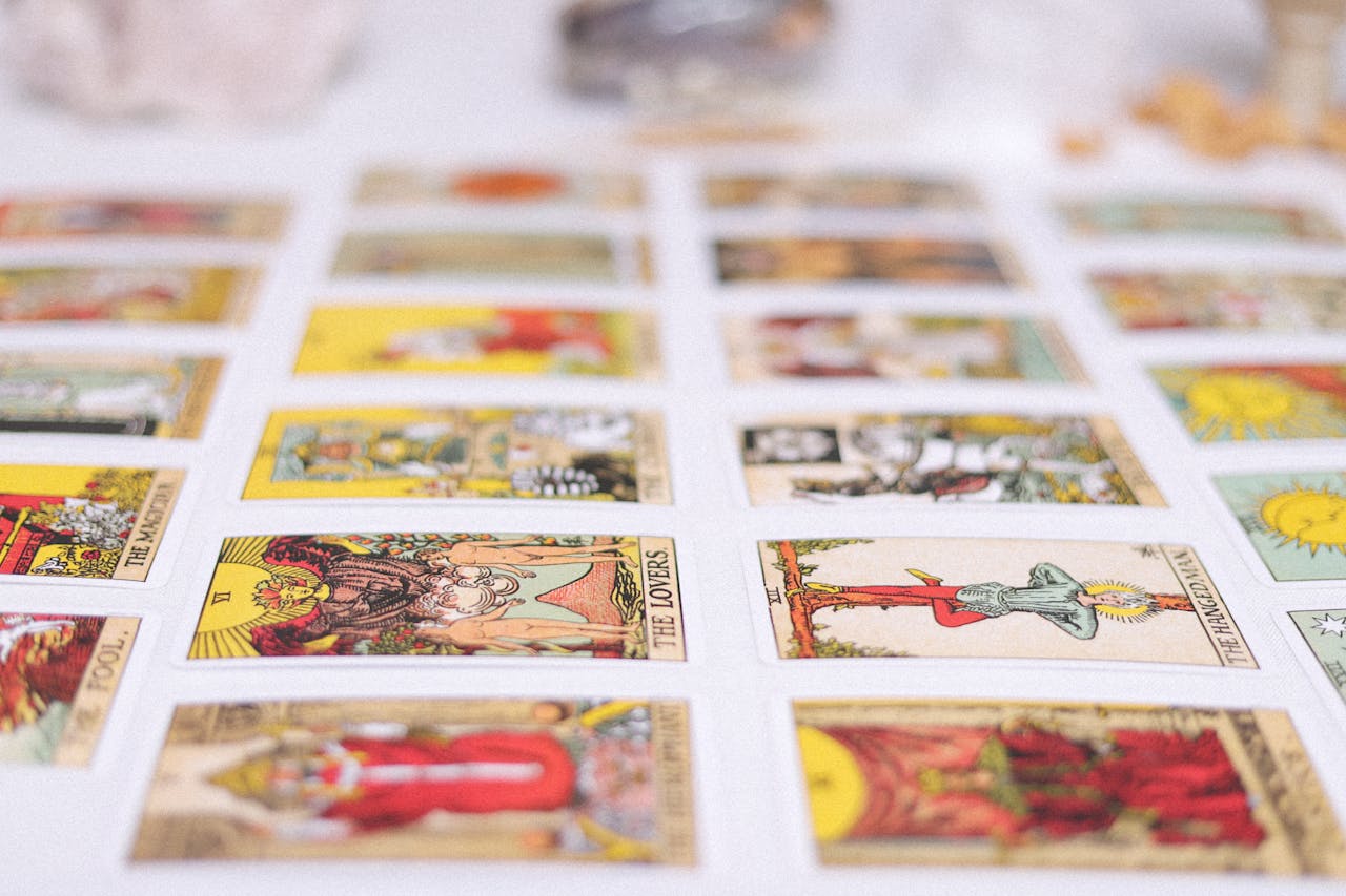 Vibrant spread of tarot cards laid out for an insightful reading session, showcasing various classic tarot designs.